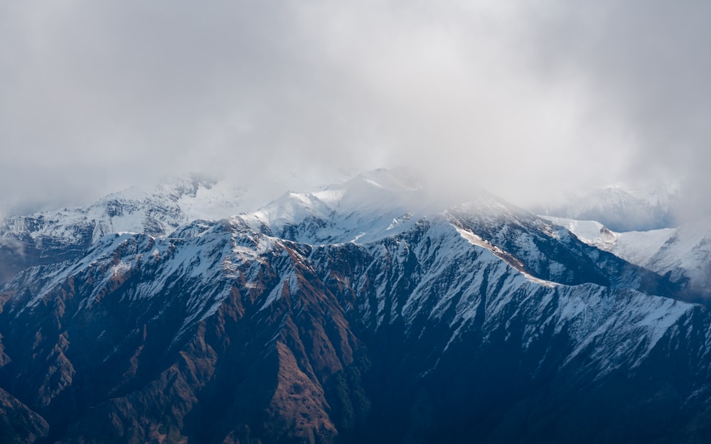 a view of a snowy mountain range from an airplane