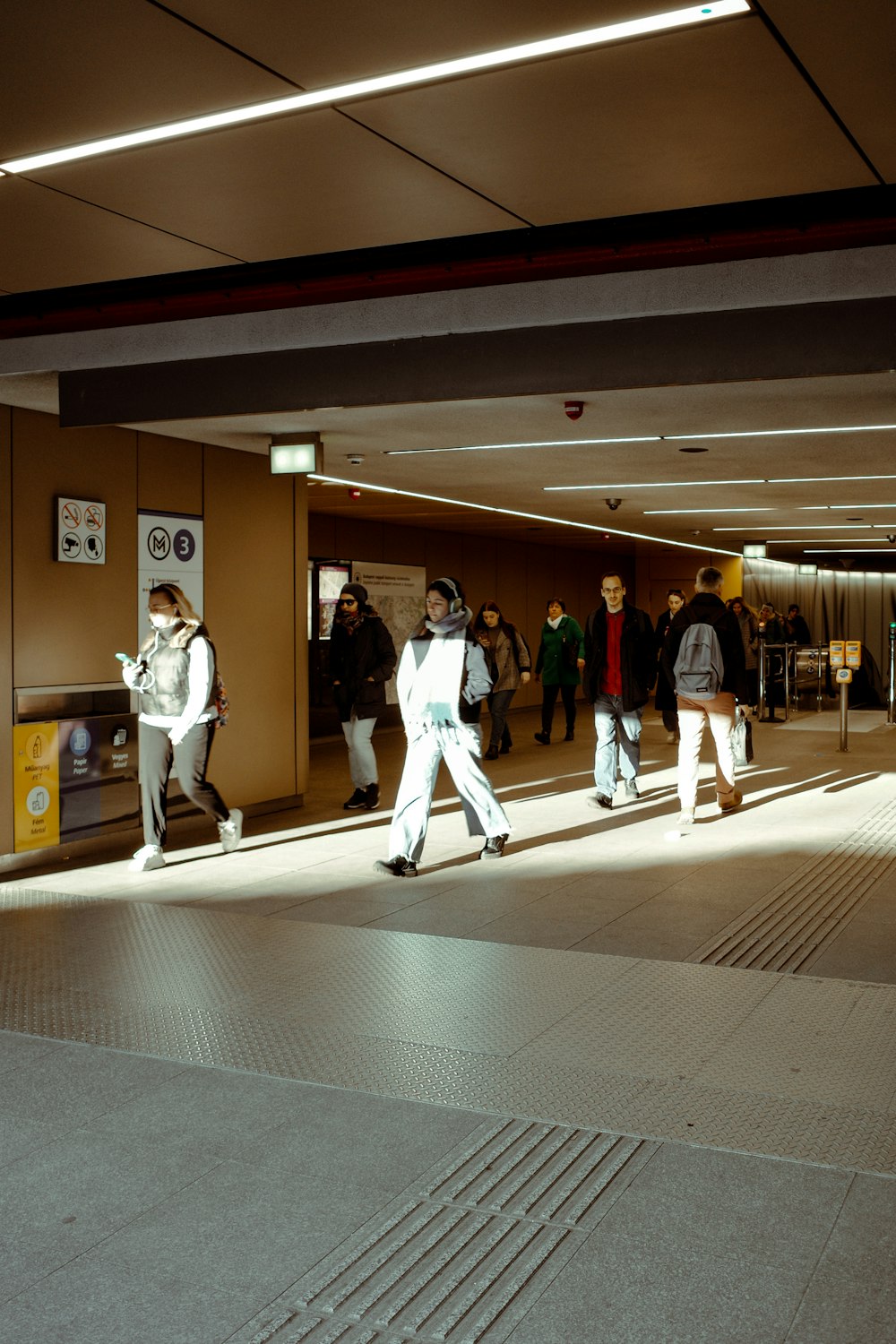 a group of people walking down a hallway