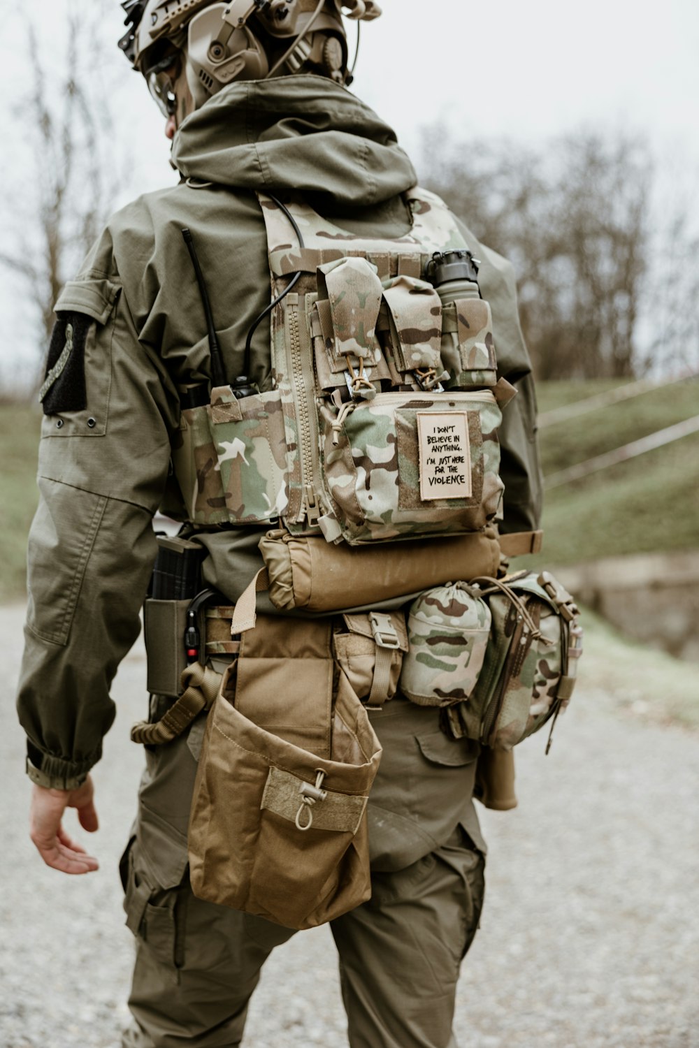 a man in a military uniform walking down a road