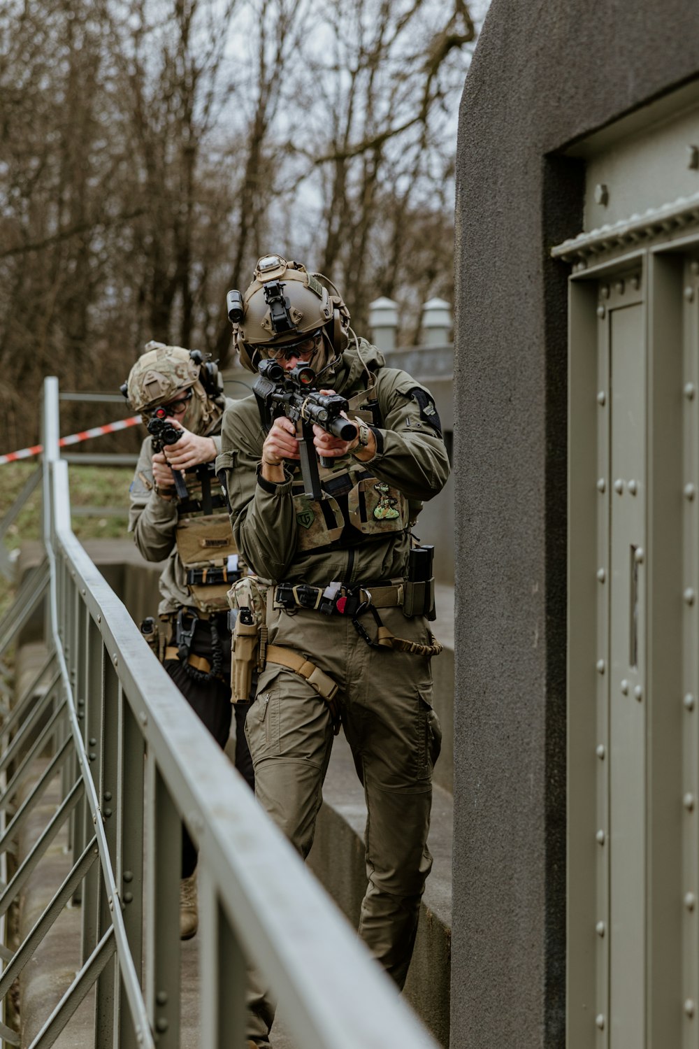 a couple of soldiers walking across a bridge