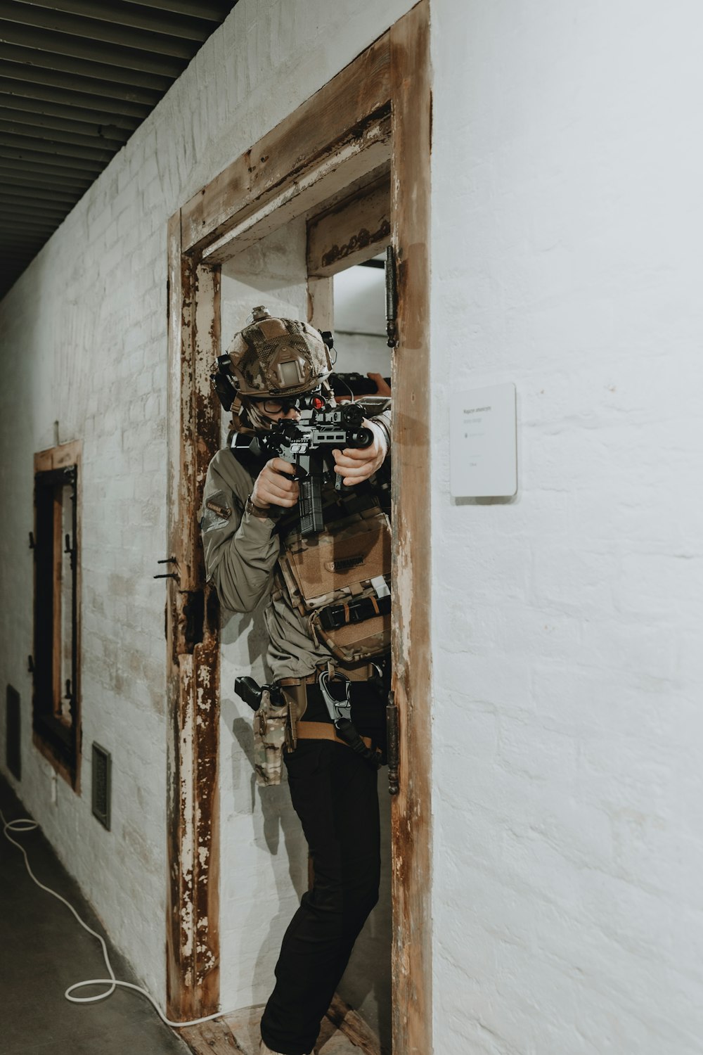 a man holding a camera standing in a doorway