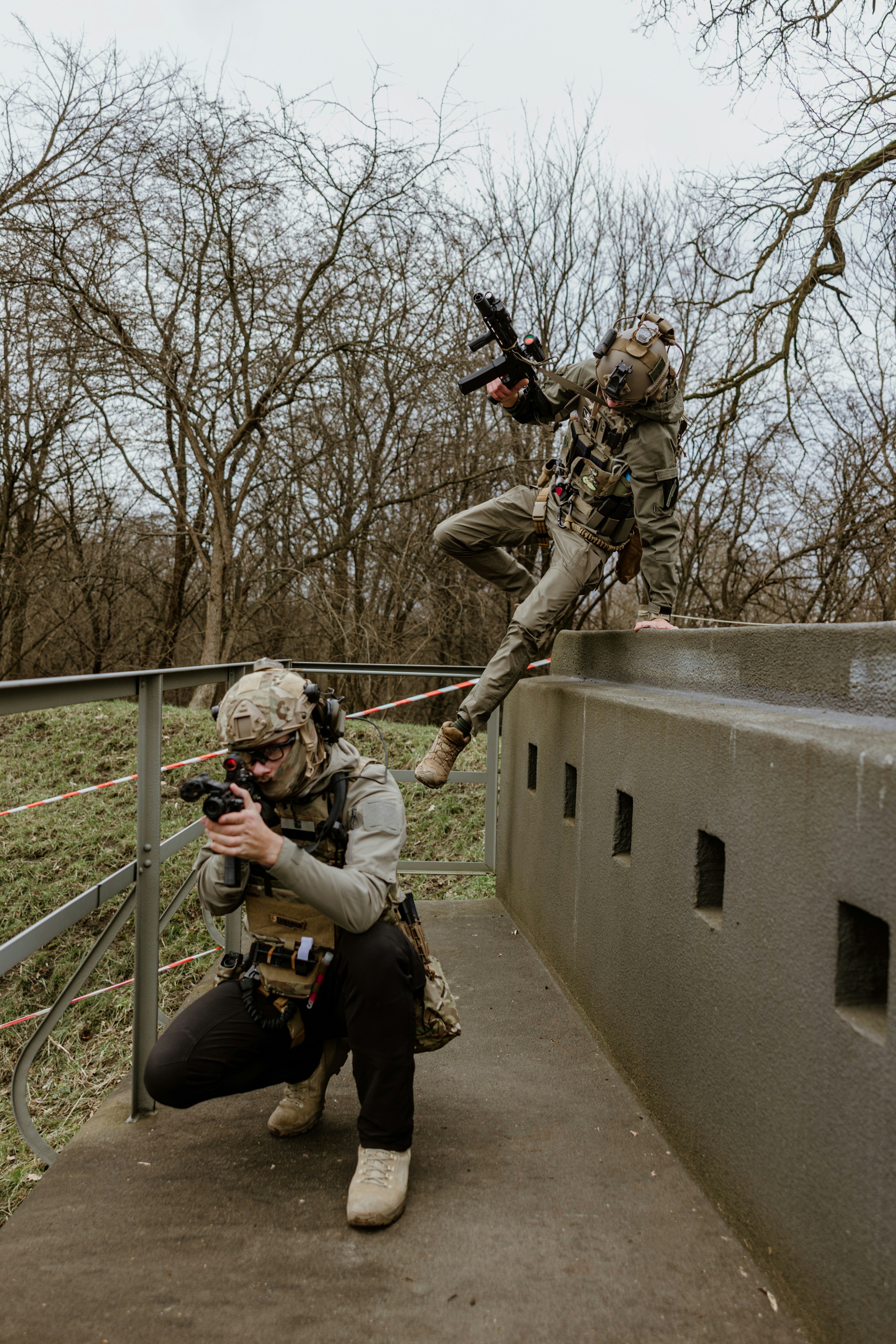 A man is taking a picture of another man on a bridge photo – Free ...