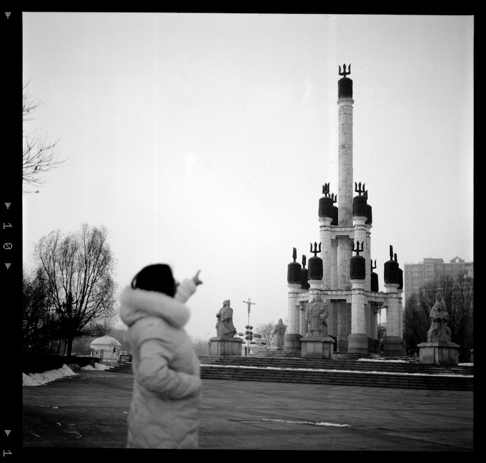 a black and white photo of a person taking a picture