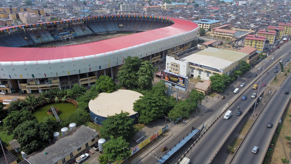 an aerial view of a soccer stadium with cars parked in front of it