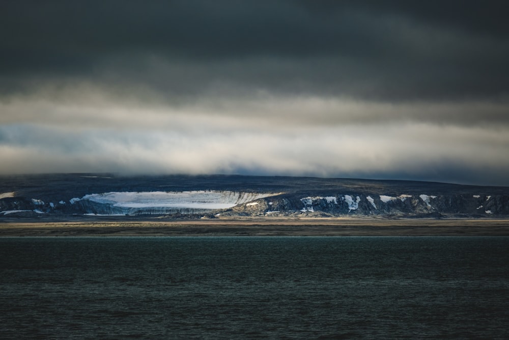 a large body of water under a cloudy sky