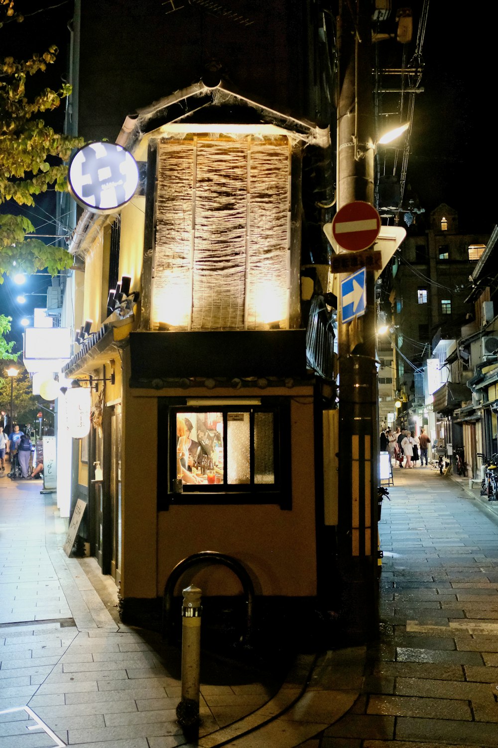 a small building on a city street at night