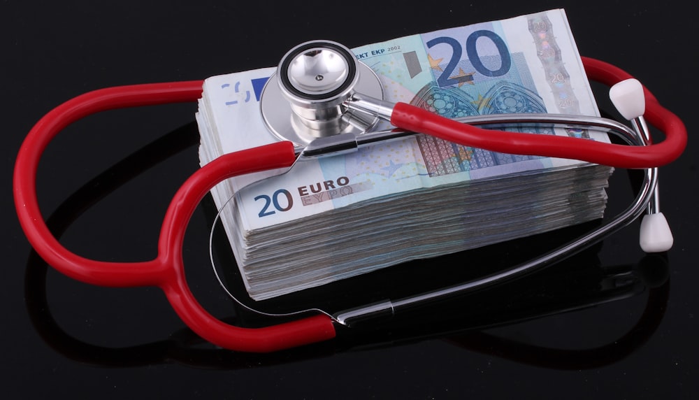 a stethoscope on top of a pile of euro bills