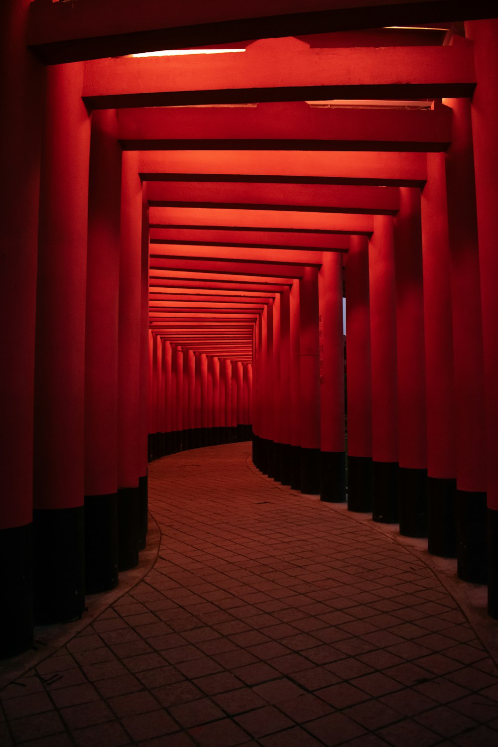 a tunnel of red lights in a building