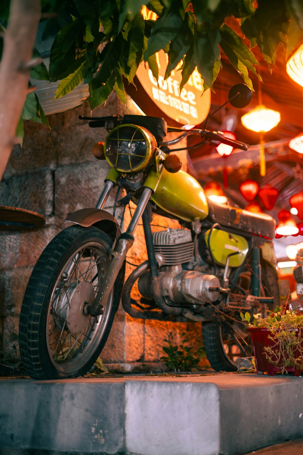 a motorcycle parked under a tree in a building