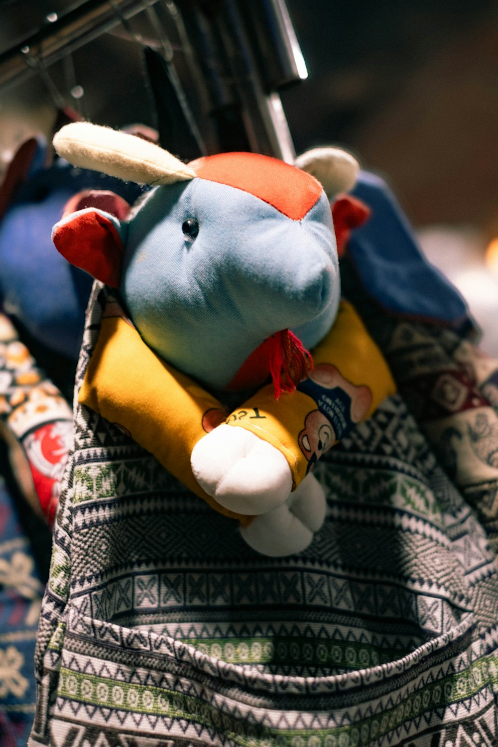 a stuffed animal hanging on a clothes rack