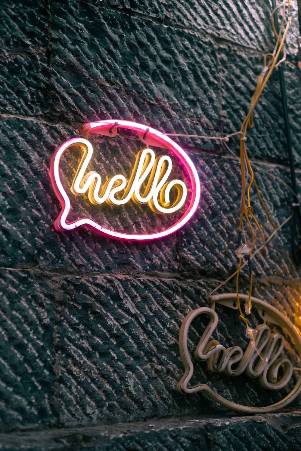 a neon sign that says hello on a wall