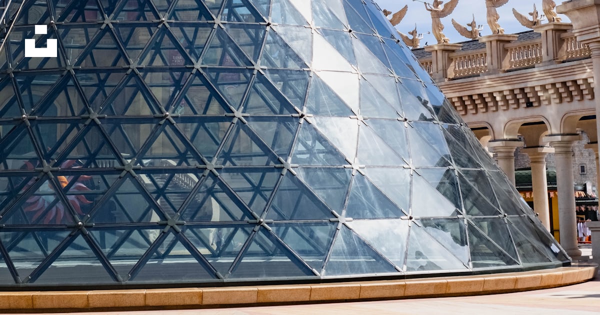 A large glass pyramid in front of a building photo – Free Building ...