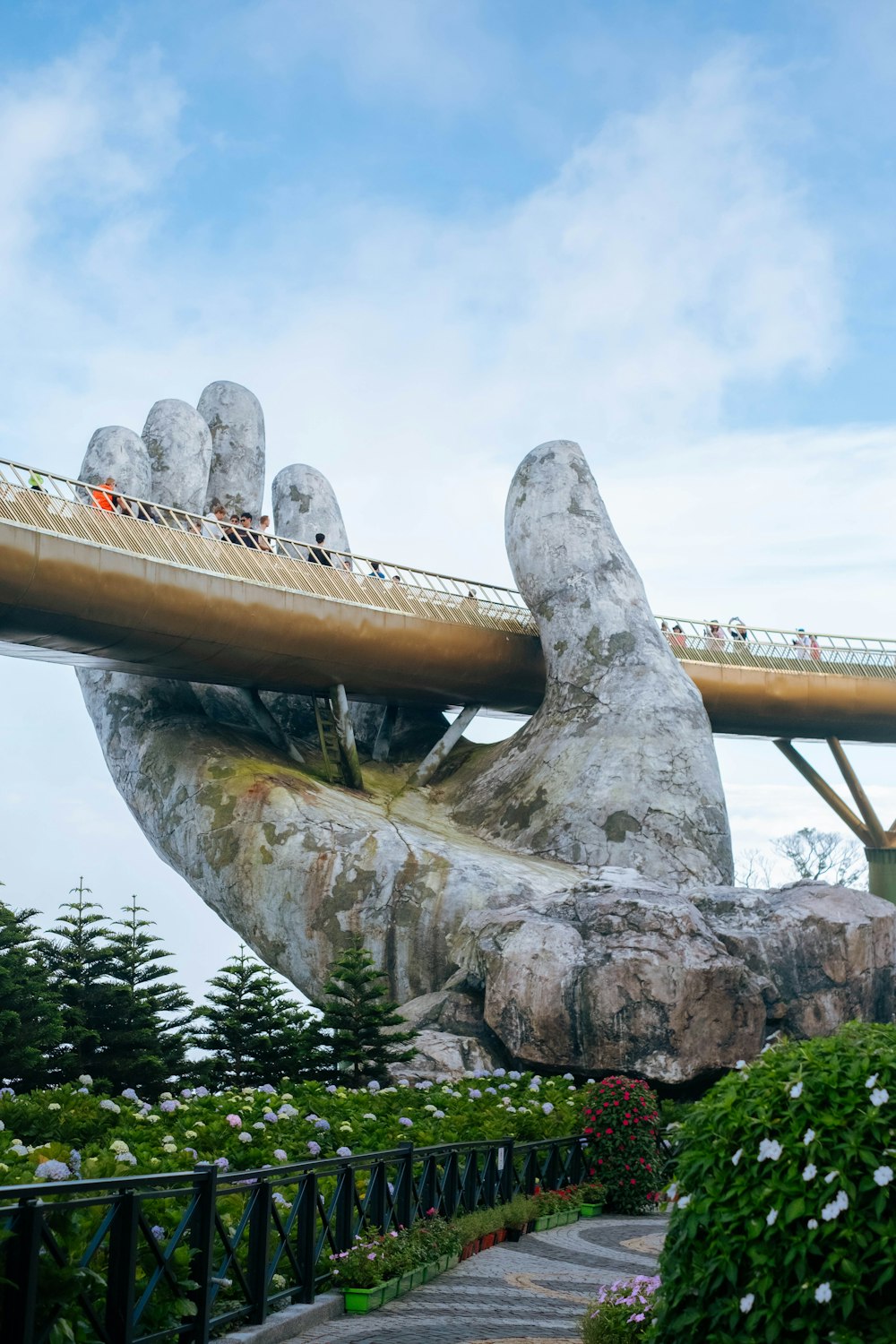 a large hand with a bridge in the background