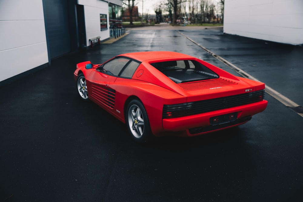 a red sports car parked in a parking lot