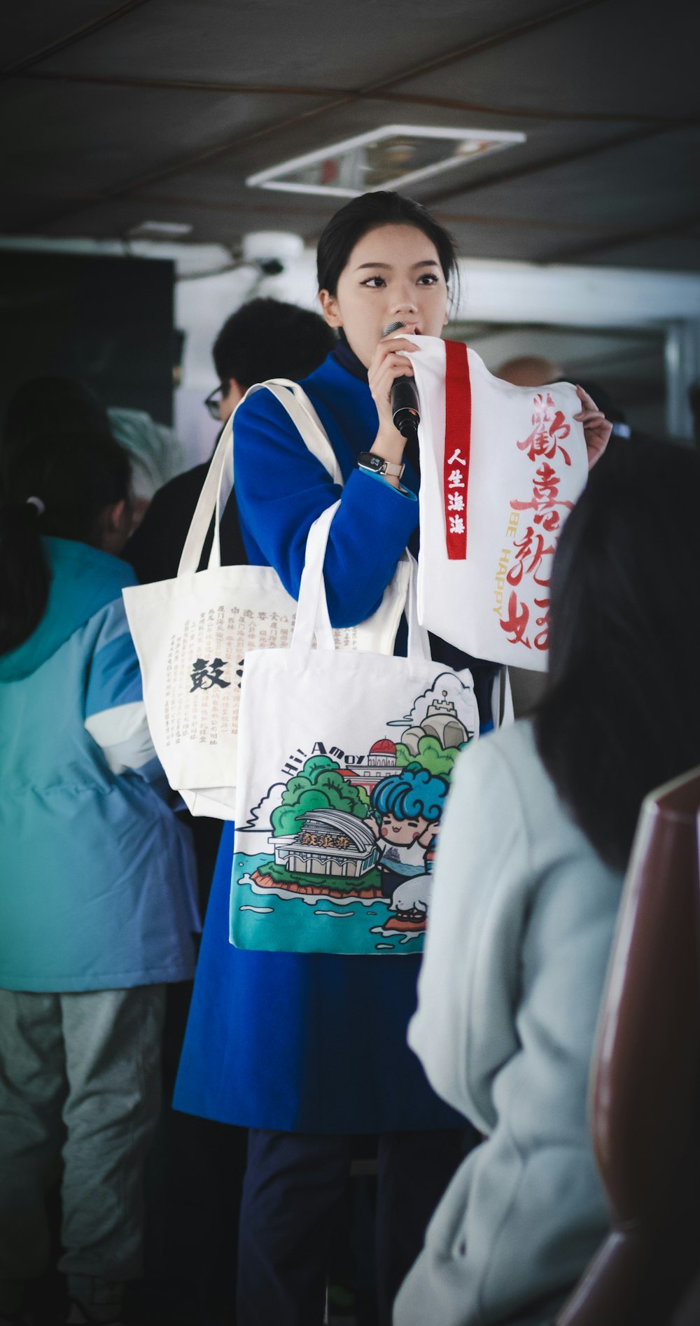 a woman holding a bag and a microphone