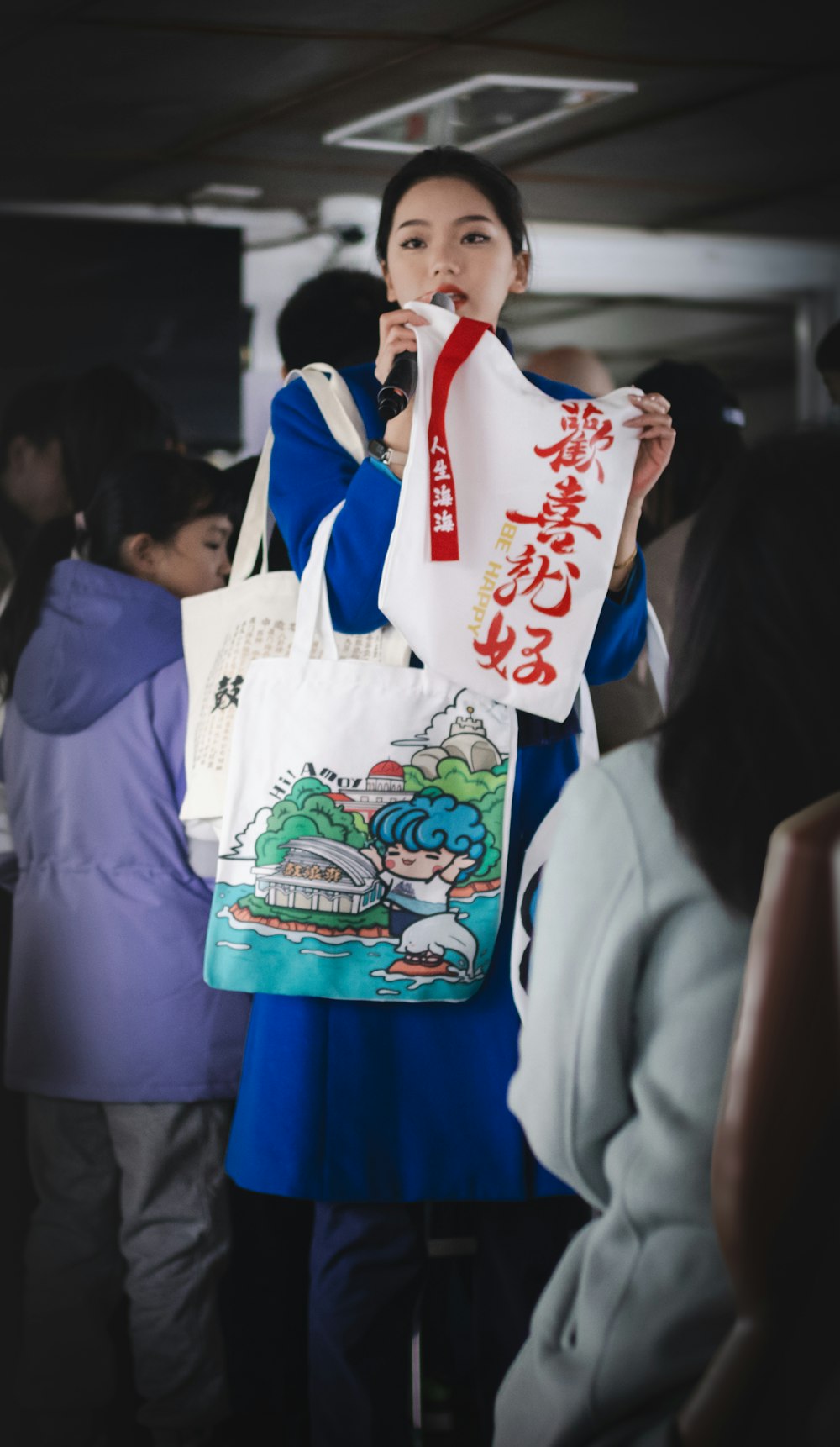 a woman in a blue dress holding a white bag