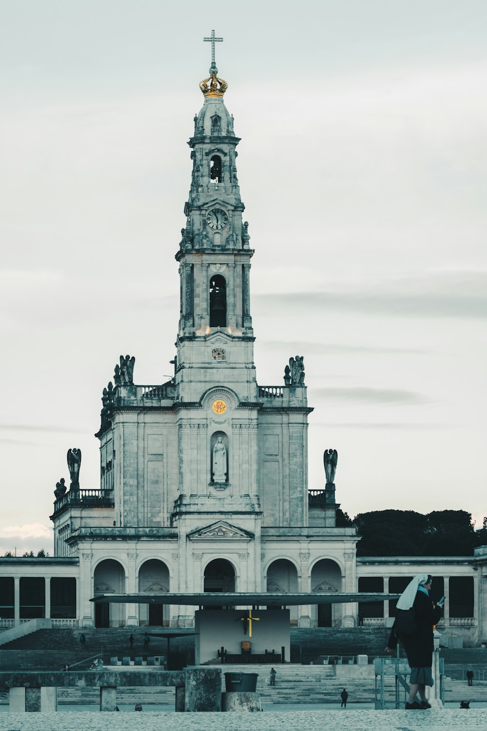 a tall white building with a clock tower