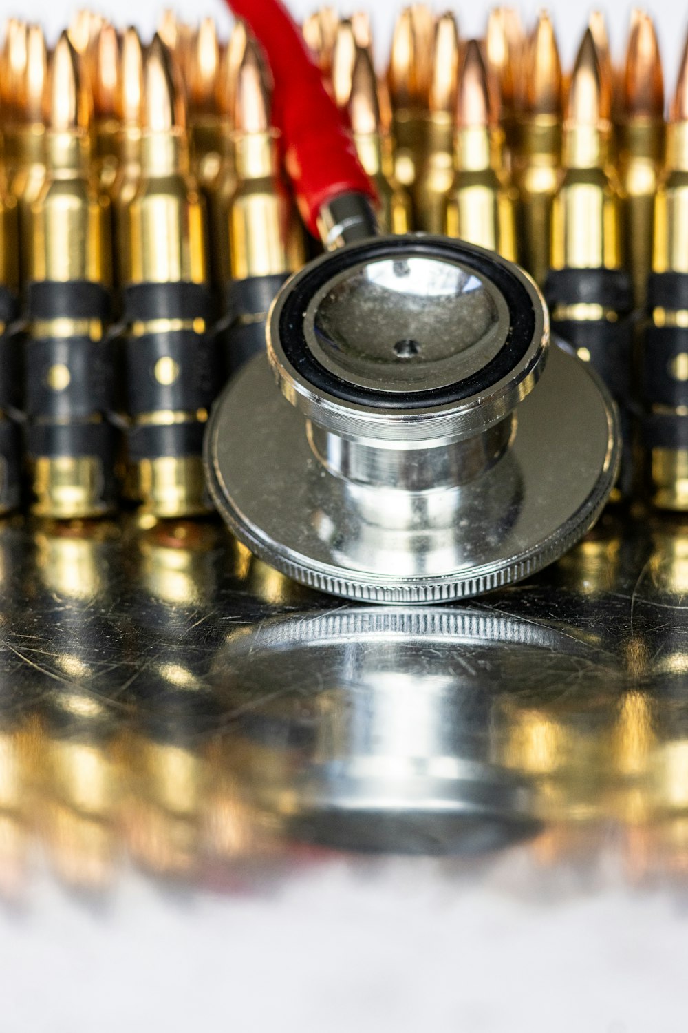 a stethoscope sitting on top of a pile of bullet casings