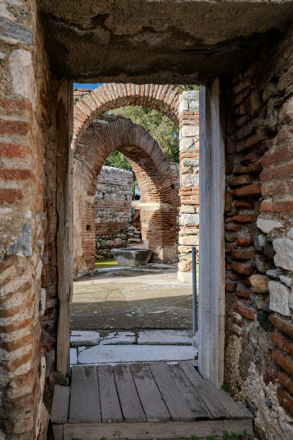 a doorway in a brick building with a wooden floor