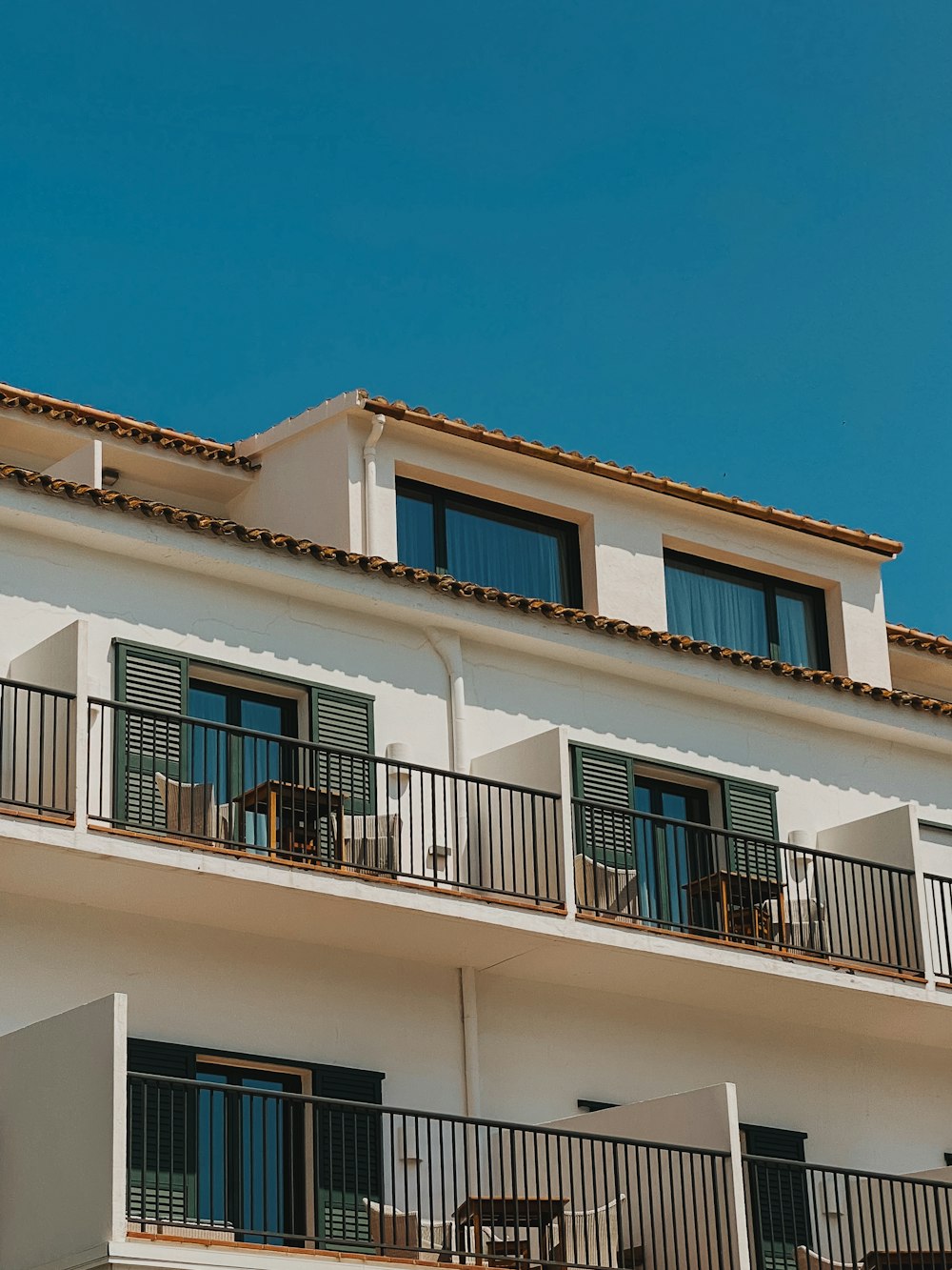 a white building with balconies and balconies on the balconies