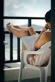 a woman sitting in a chair reading a book
