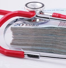 a stethoscope resting on top of a stack of money