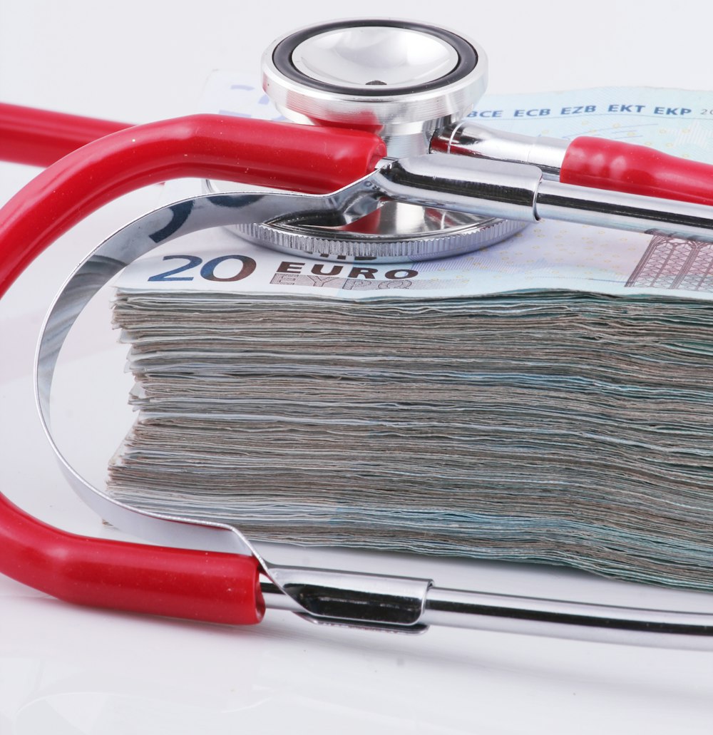 a stethoscope resting on top of a stack of money