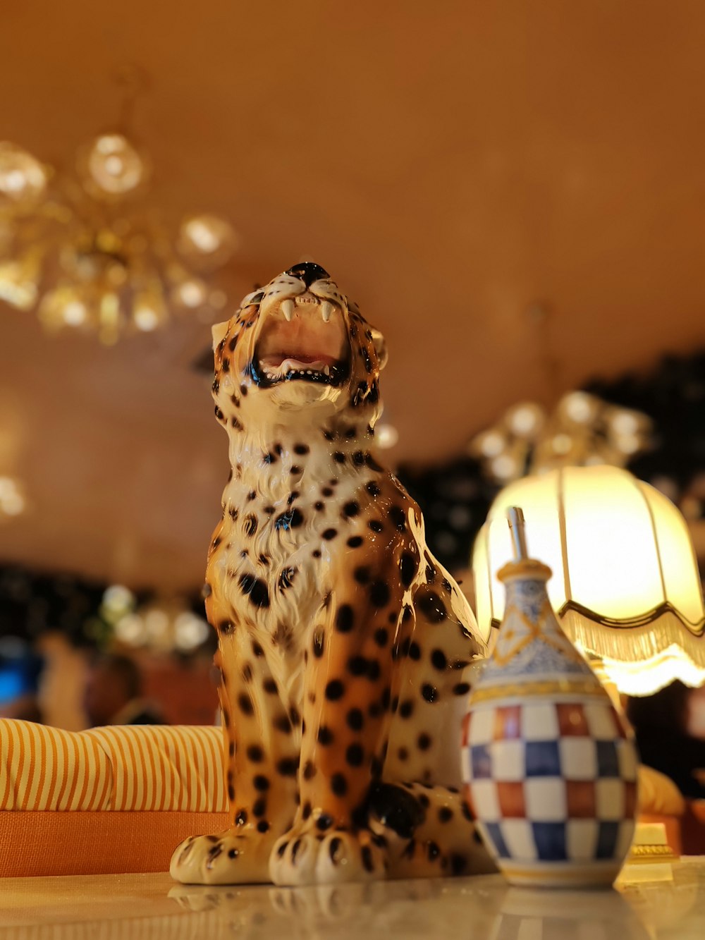 a cheetah figurine sitting on top of a table