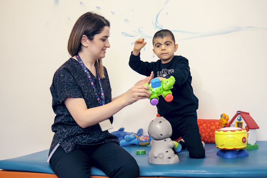 a woman playing with a child on a table