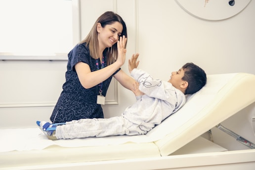 a woman is giving a boy a high five