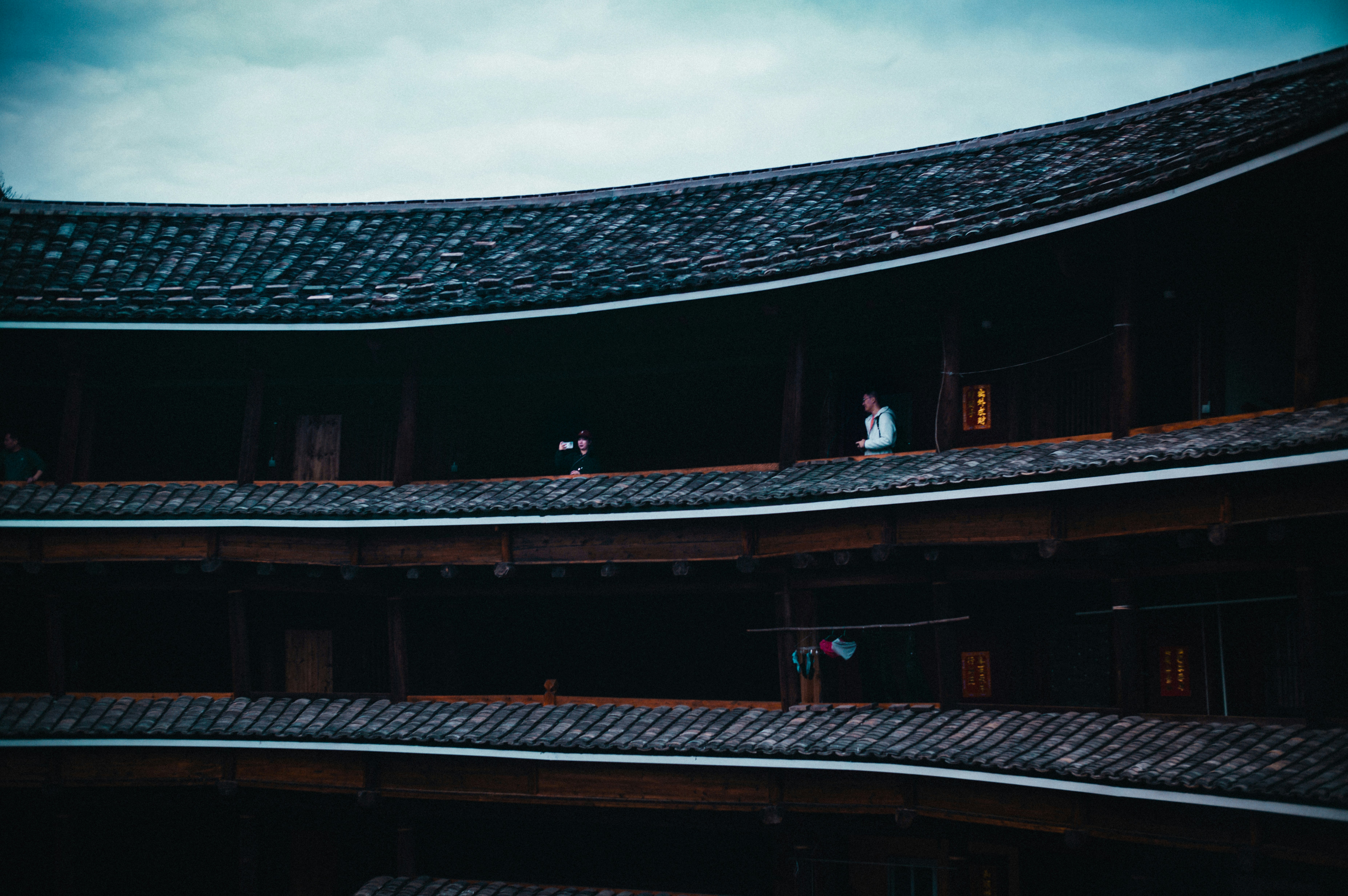 a couple of people standing on top of a roof
