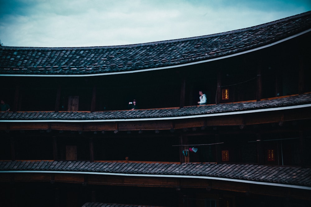 a couple of people standing on top of a roof