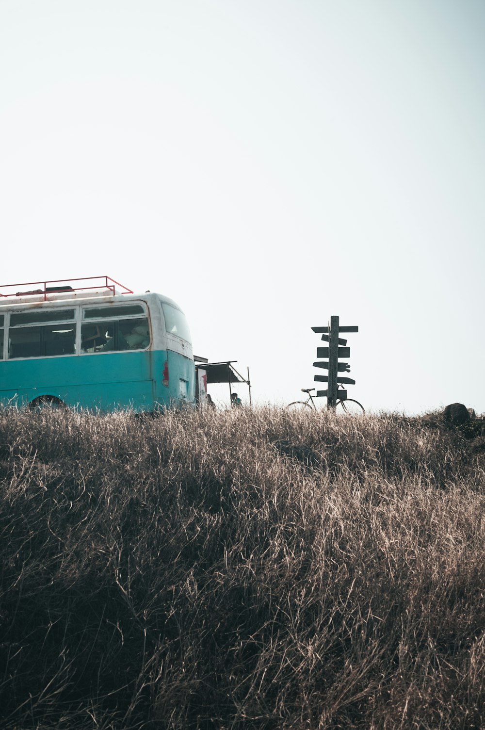 a bus is parked on a grassy hill