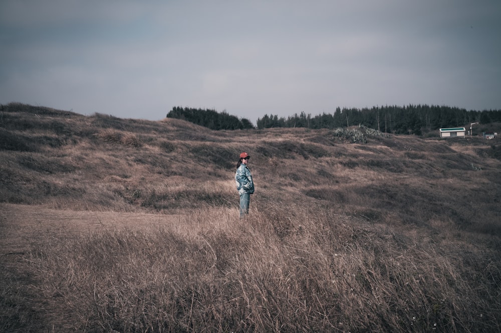 a person standing in a field of tall grass