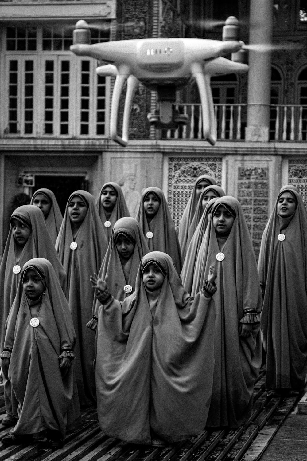 a group of women standing in front of a building