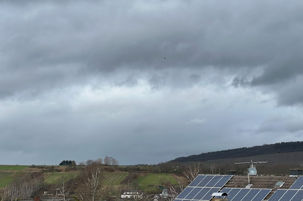 a group of houses with solar panels on the roof