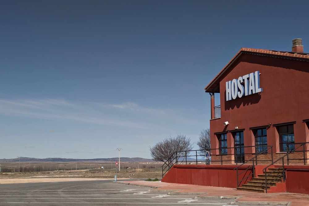 a red building with a sign that reads hotel