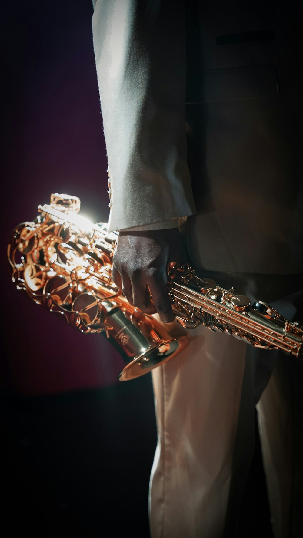 a close up of a person holding a saxophone