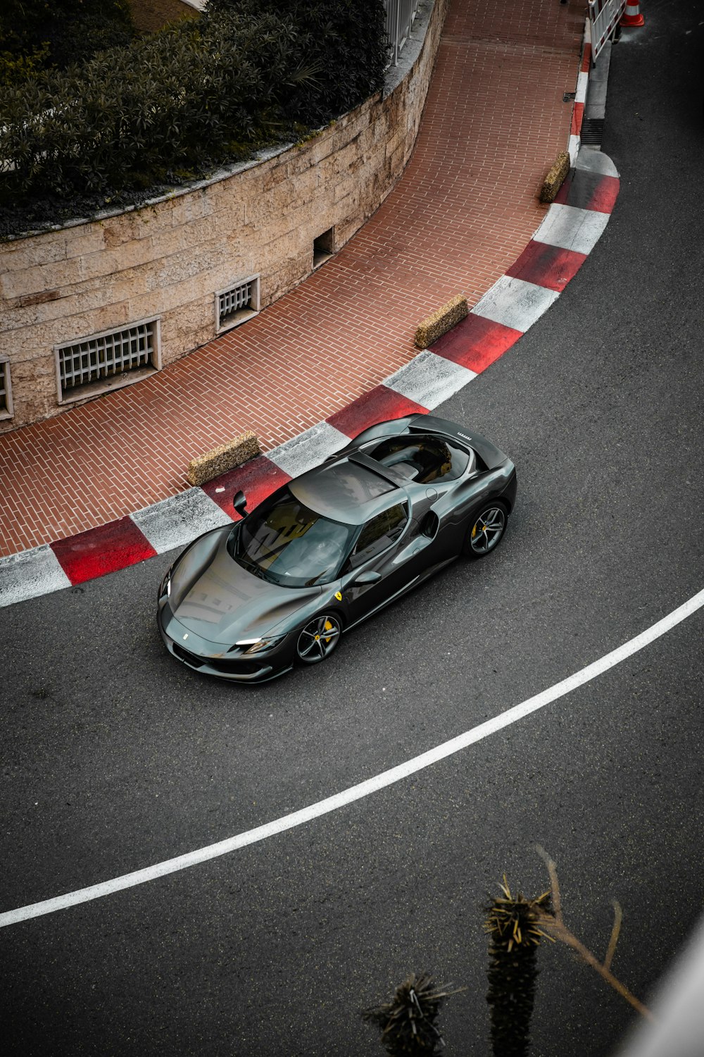 a black sports car driving down a winding road