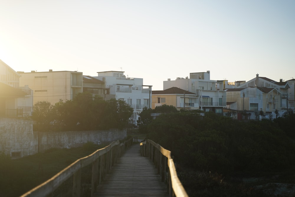 a wooden walkway leading to a row of houses