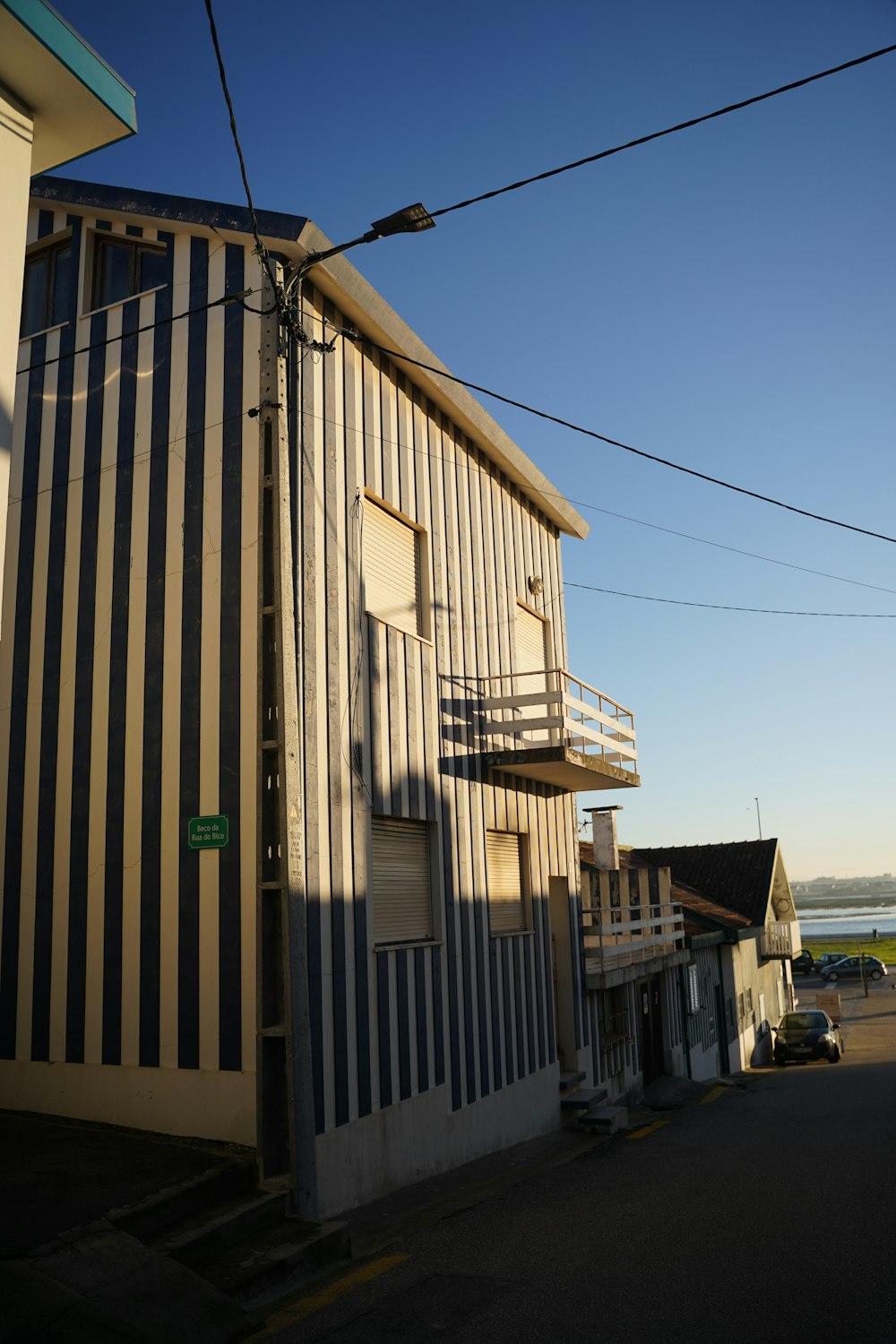 a building with a balcony next to a street