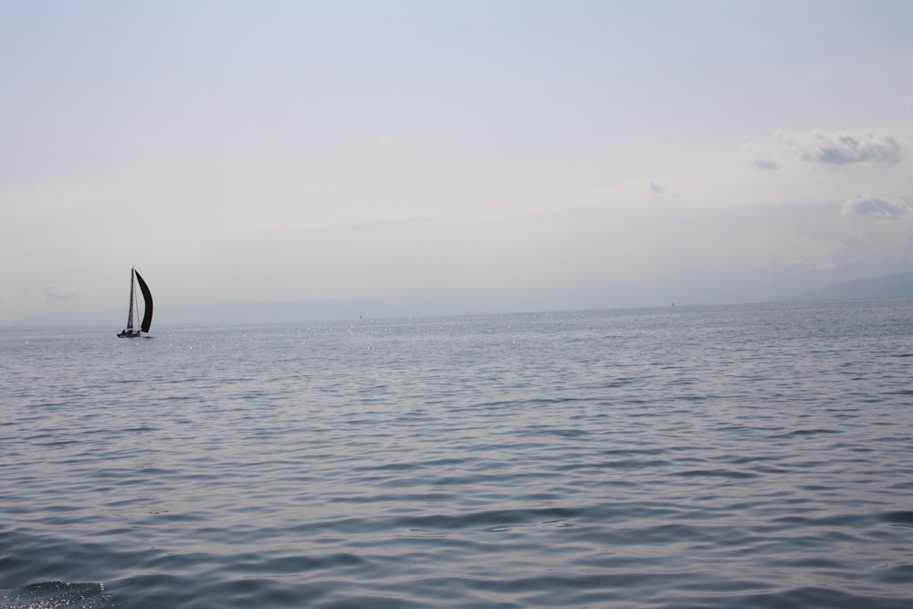 a sailboat in the middle of the ocean