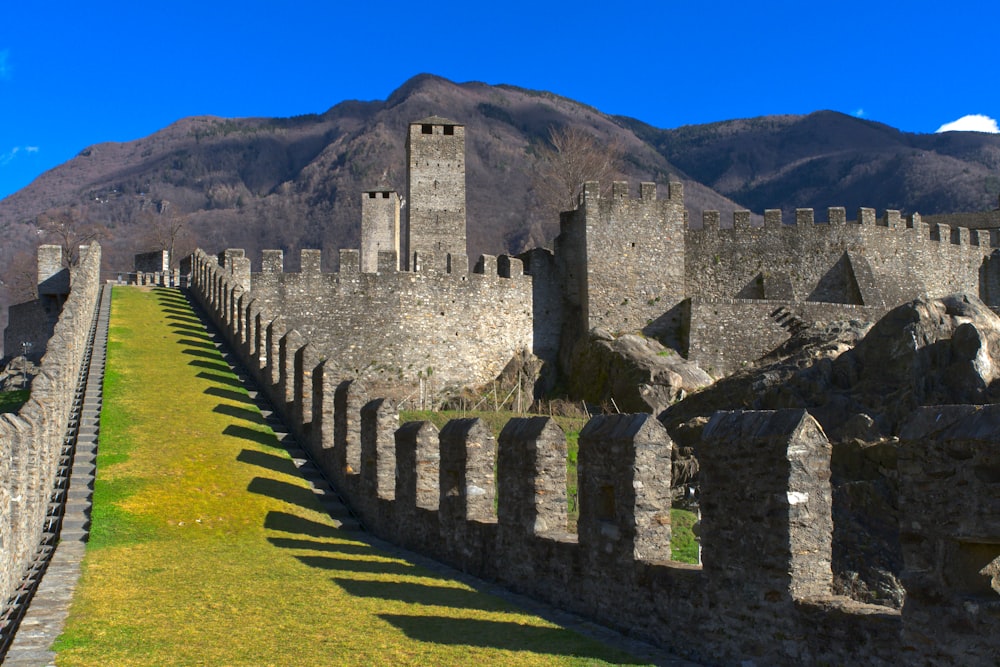 a large stone castle with a mountain in the background