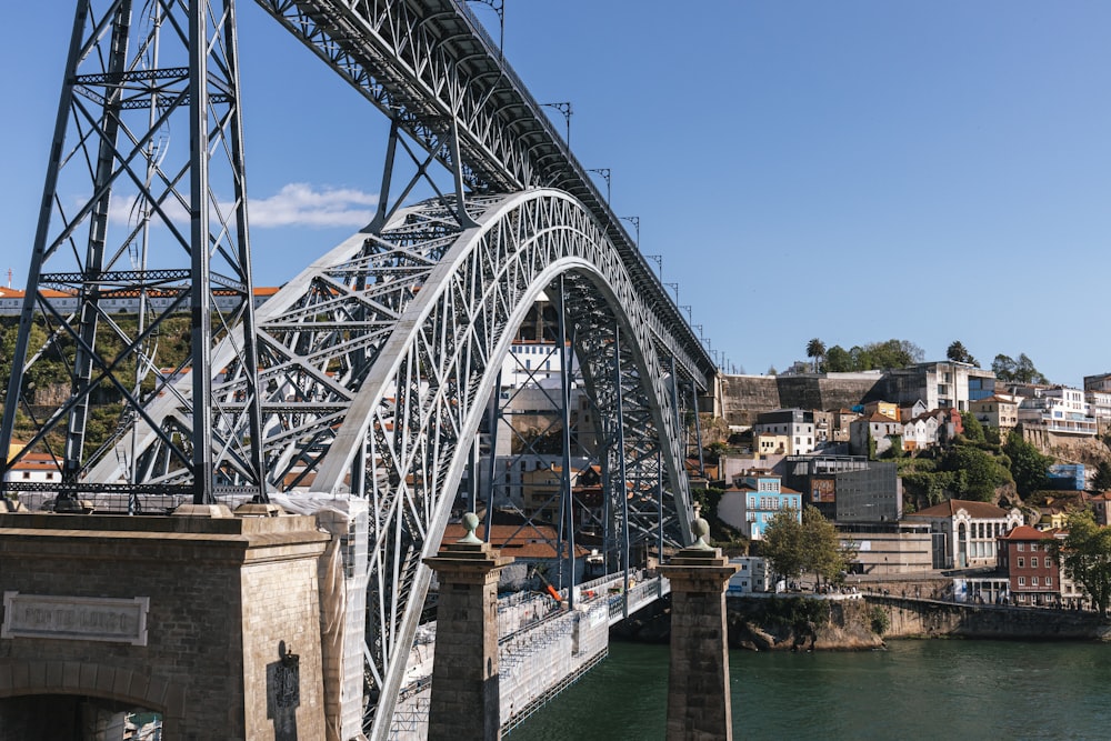 a large metal bridge spanning over a river