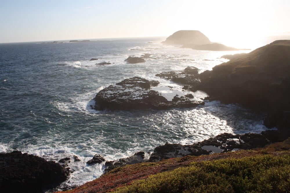 a body of water near a rocky shore