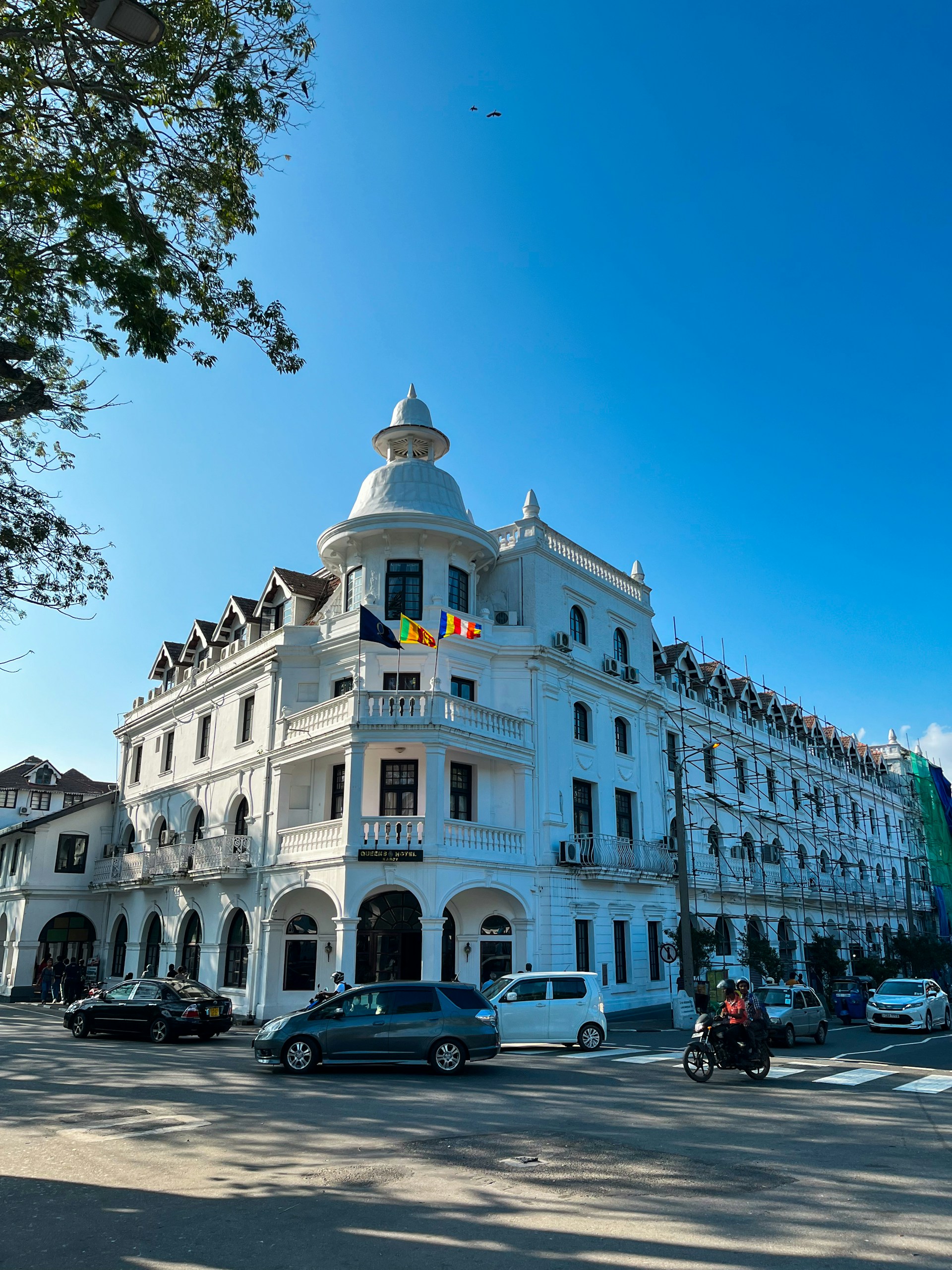 a large white building sitting on the side of a road