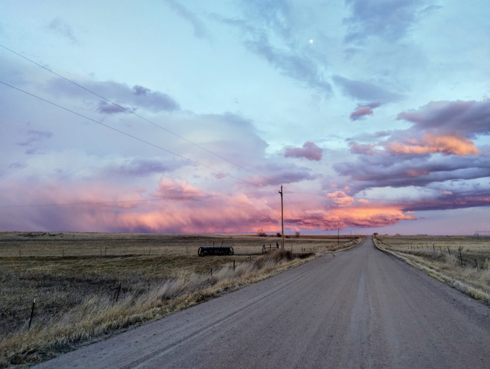 a dirt road in the middle of a field