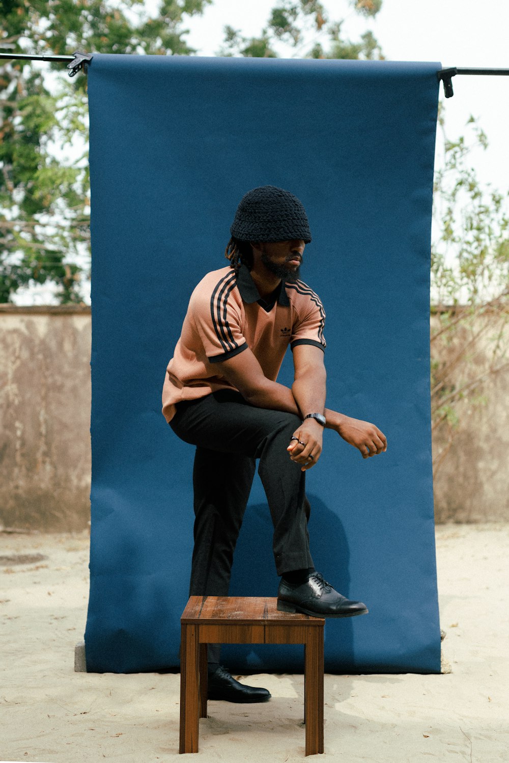 a man sitting on top of a wooden bench