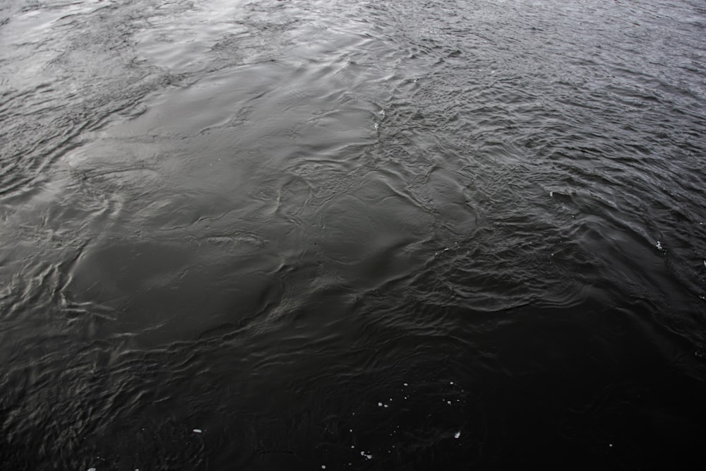 a large body of water with a sky in the background