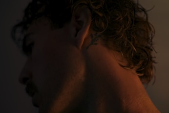 a man with a tattoo on his left ear